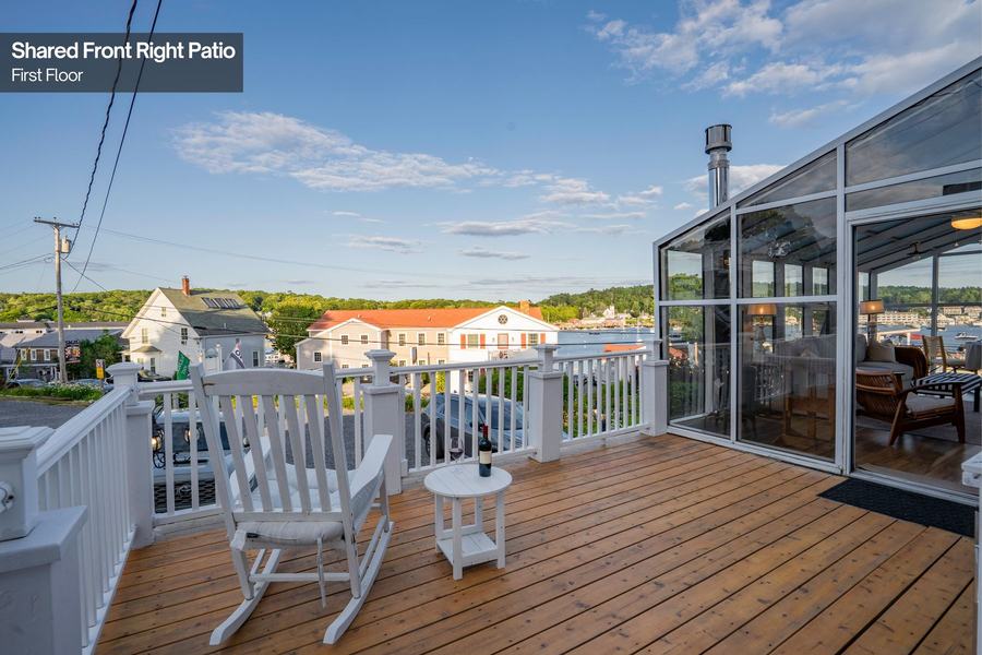 Outdoor patio with Adirondack chairs overlooking Boothbay Harbor