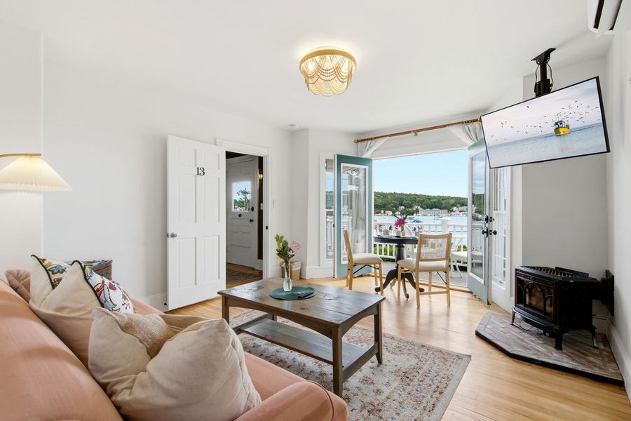 Coastal living room opening onto a balcony with Boothbay Harbor views