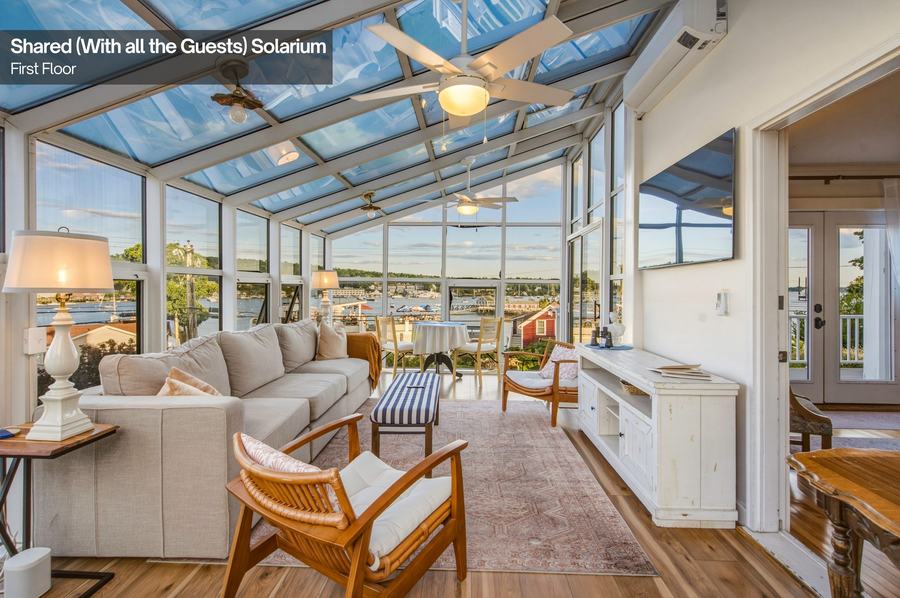 Sunlit guest solarium with comfortable coastal-style seating