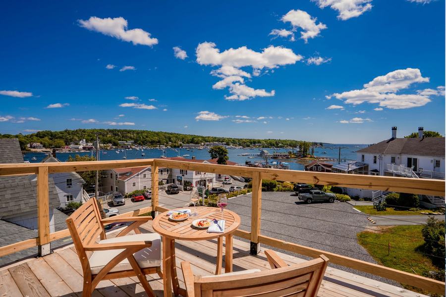 Rooftop dining table and chairs overlooking Boothbay Harbor.