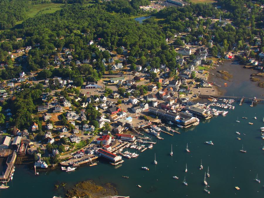 Sailboats on the water in Boothbay Harbor, Maine, on a calm summer afternoon