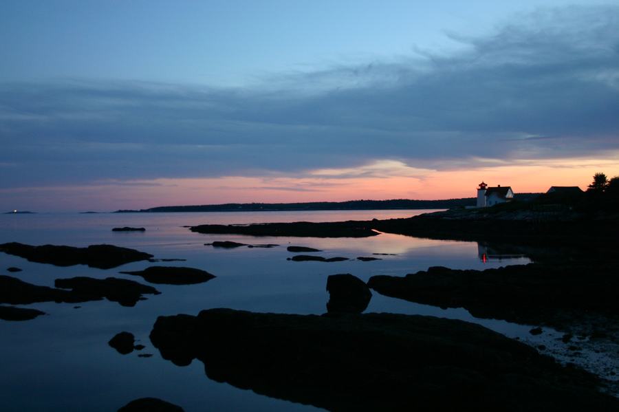 A quiet dock and calm water on the edge of Boothbay Harbor, Maine, in soft evening light