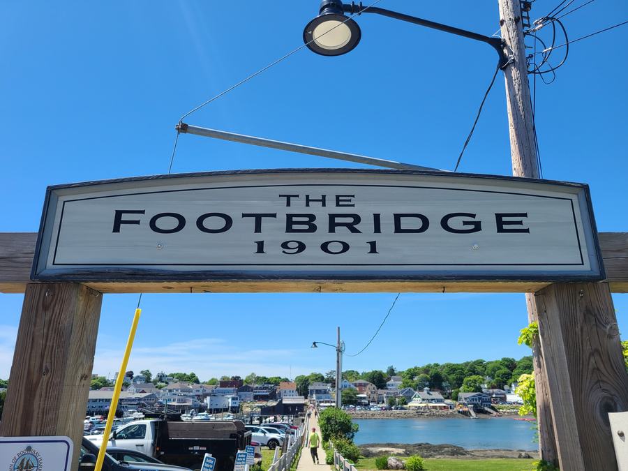 Pedestrians on the waterfront footbridge in downtown Boothbay Harbor, Maine